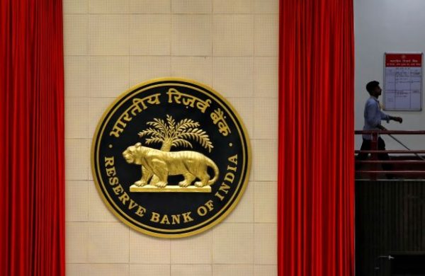 A worker walks past the logo of Reserve Bank of India (RBI) inside its office in New Delhi, India, 8 July 2019 (Photo: Reuters/Anushree Fadnavis).