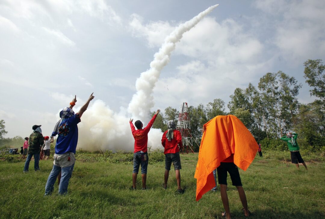 Participants in a rocket competition cheer after their rocket was successfully launched during the rocket festival known as 'Bun Bangfai' in Yasothon, northeast of Bangkok, May 13, 2012 (Photo: Reuters/Chaiwat Subprasom).