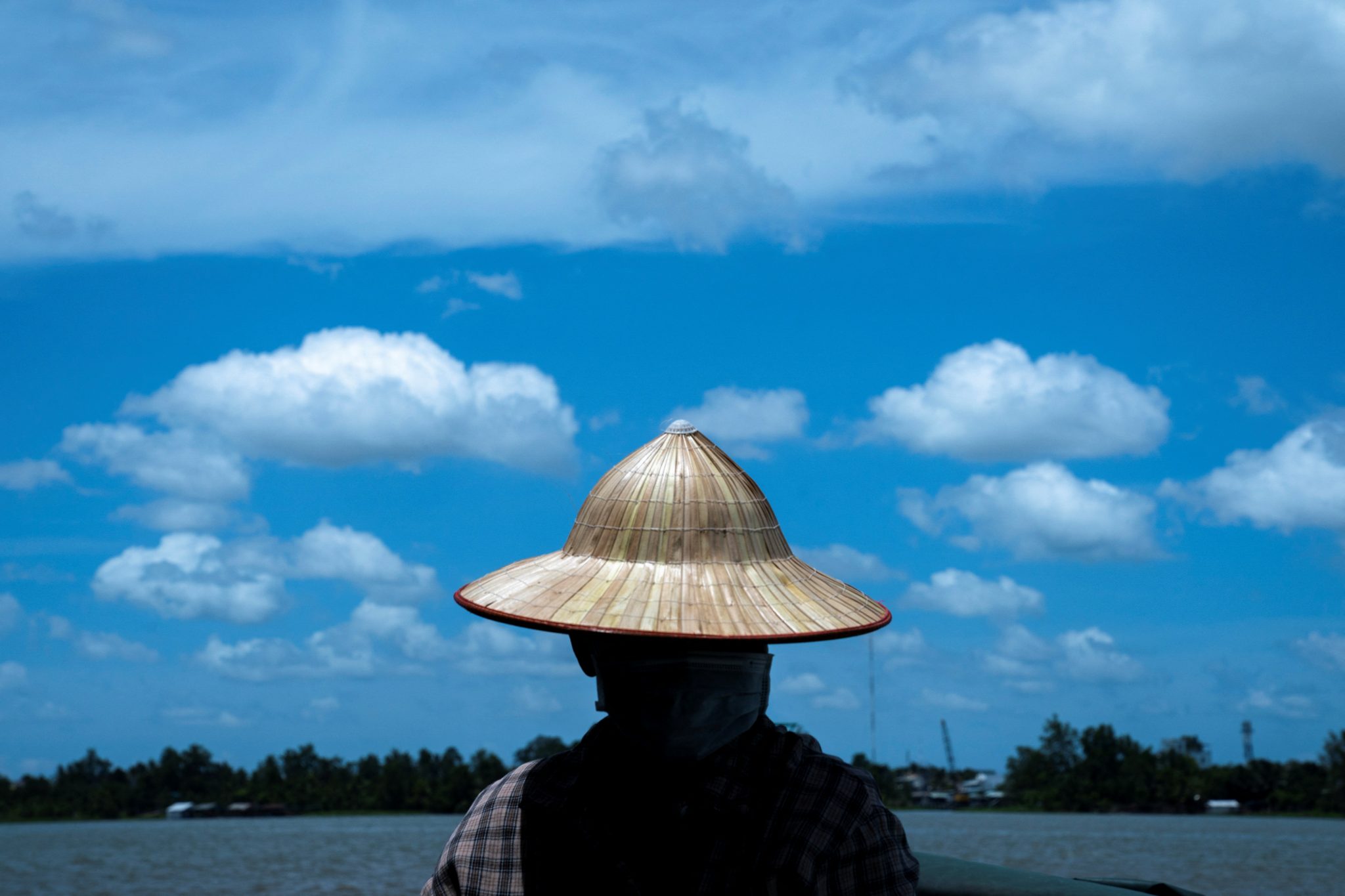 A boat driver rides along the Mekong river located in the Mekong river which was affected by sediment in Mekong's regional capital Can Tho, Vietnam, 25 May 2022 (Photo: REUTERS/Athit Perawongmetha)